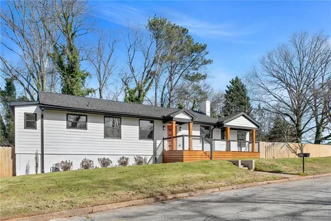 a view of a yard in front view of a house