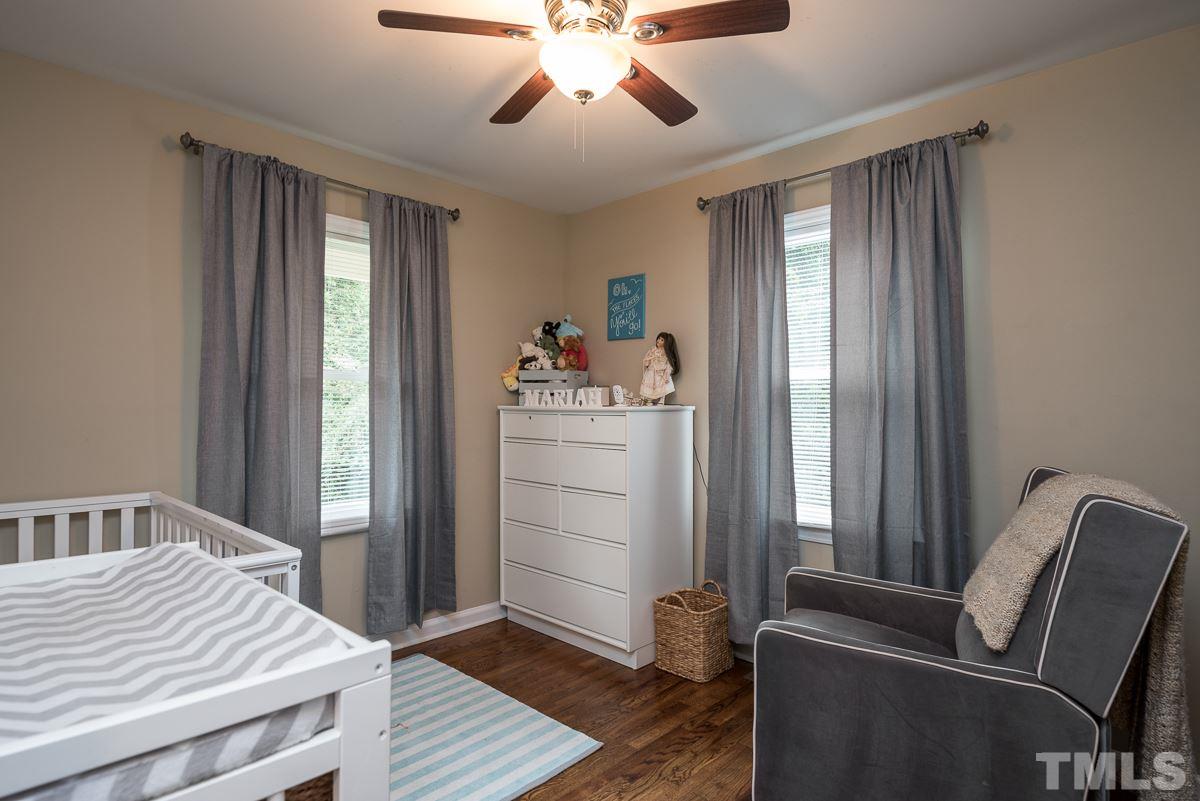 2212 Rumson Road Raleigh, NC 27610 - Photo 12 of 19 a room that has a bed and a chandelier