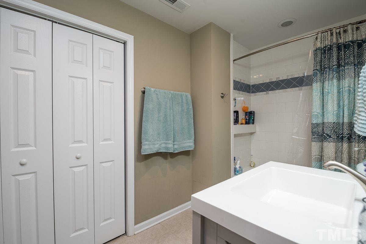 2212 Rumson Road Raleigh, NC 27610 - Photo 17 of 19 a bedroom with a bed and a table