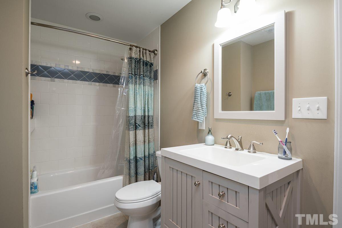2212 Rumson Road Raleigh, NC 27610 - Photo 18 of 19 a bathroom with a sink toilet and shower