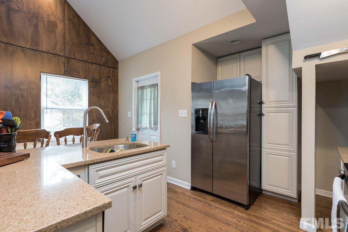 2212 Rumson Road Raleigh, NC 27610 - Photo 8 of 19 a kitchen with stainless steel appliances granite countertop a refrigerator and a stove top oven