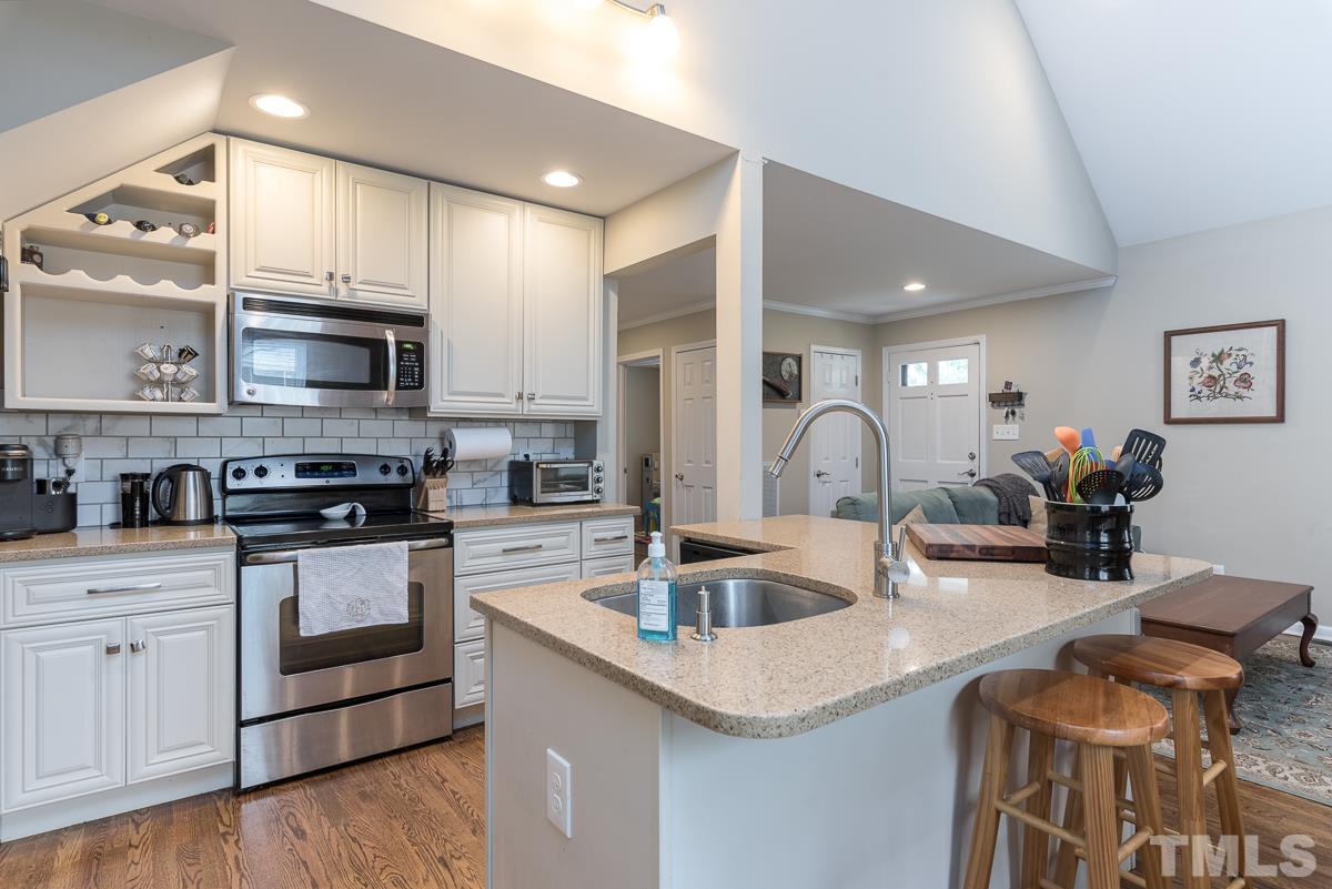 2212 Rumson Road Raleigh, NC 27610 - Photo 10 of 19 a kitchen with stainless steel appliances granite countertop a sink and cabinets
