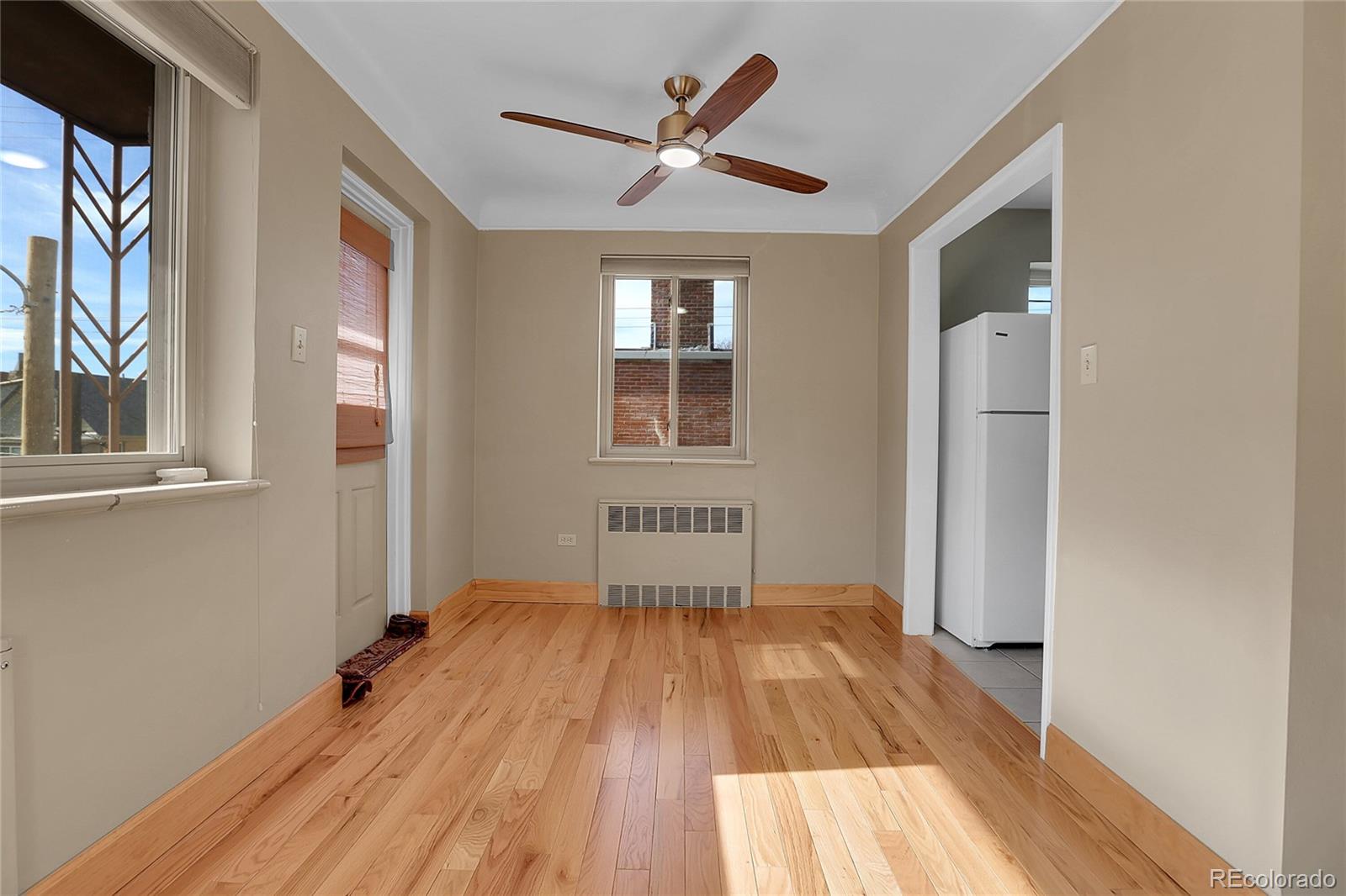1175 Emerson Street, Unit 202 Denver, CO 80218 - Photo 11 of 31 a view of empty room with wooden floor and fan