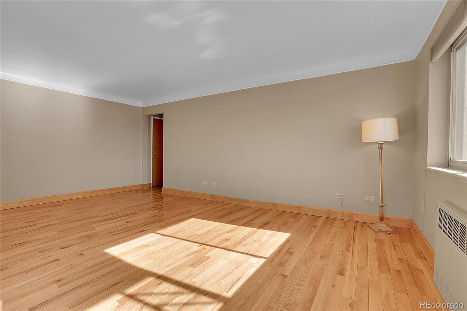 1175 Emerson Street, Unit 202 Denver, CO 80218 - Photo 12 of 31 a view of an empty room with wooden floor