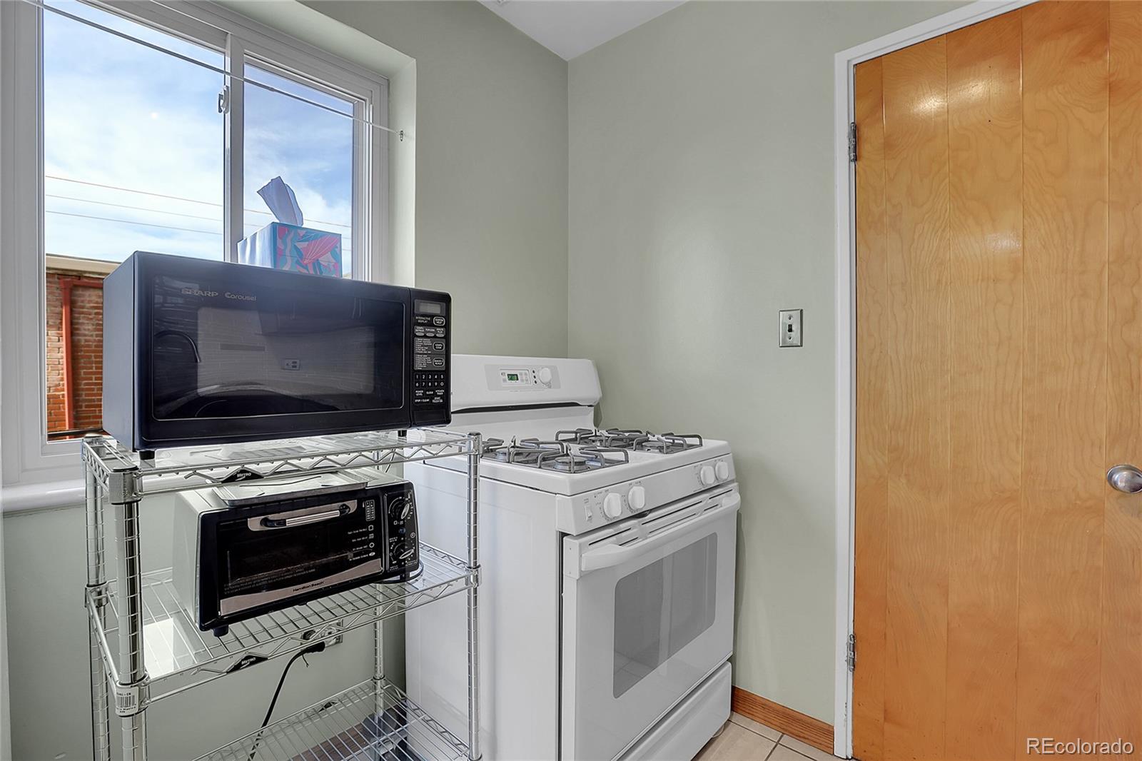 1175 Emerson Street, Unit 202 Denver, CO 80218 - Photo 16 of 31 a stove top oven sitting inside of a kitchen