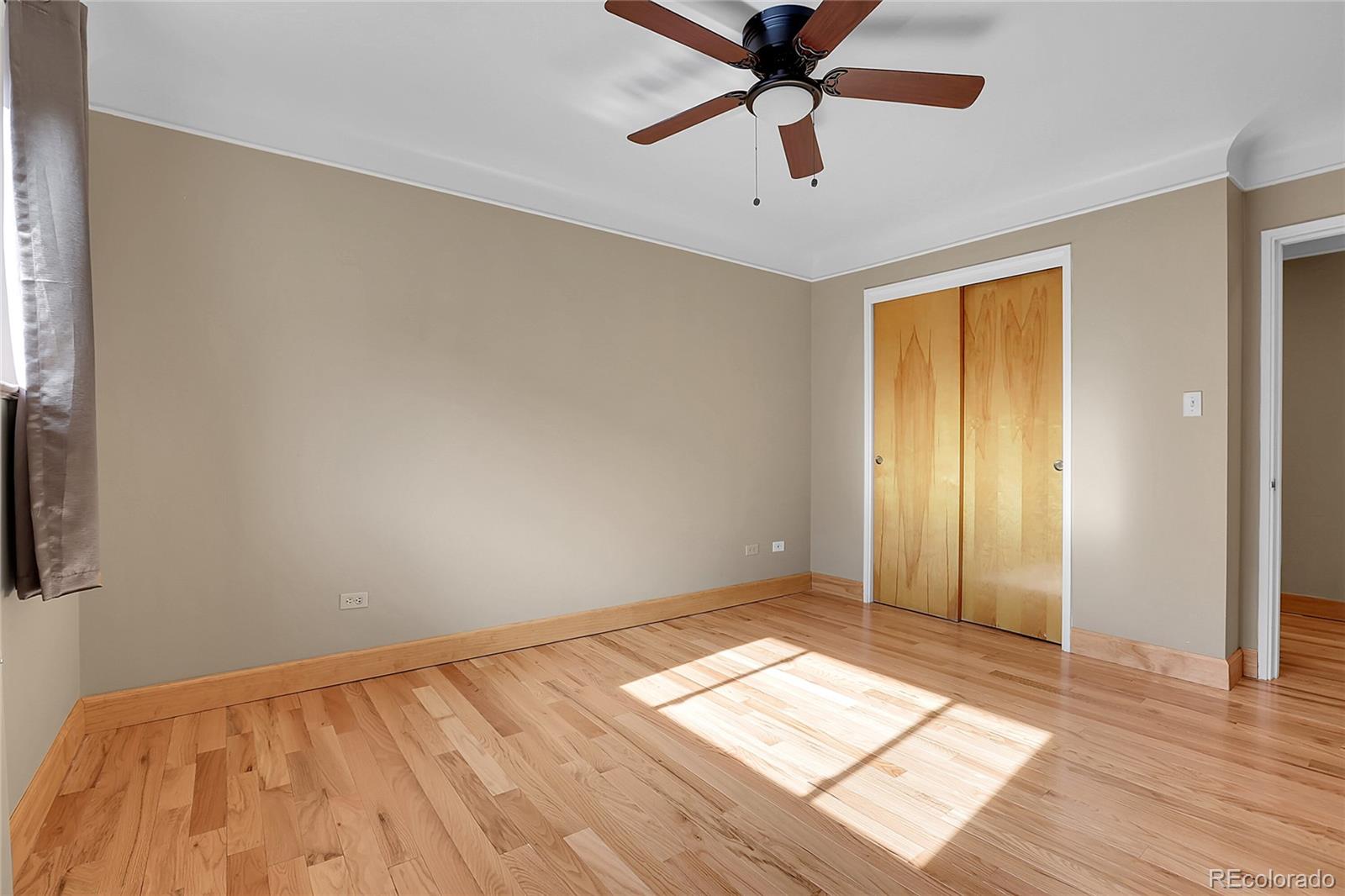 1175 Emerson Street, Unit 202 Denver, CO 80218 - Photo 19 of 31 a view of empty room with wooden floor and fan