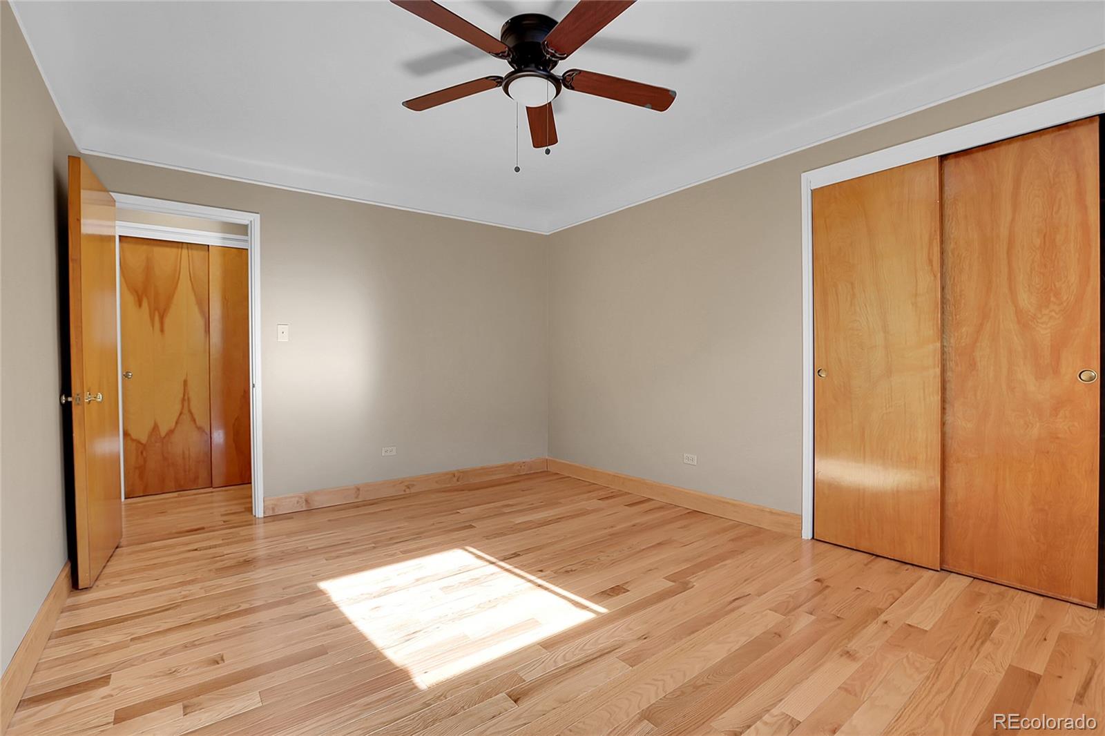 1175 Emerson Street, Unit 202 Denver, CO 80218 - Photo 23 of 31 a view of an empty room and window and wooden floor