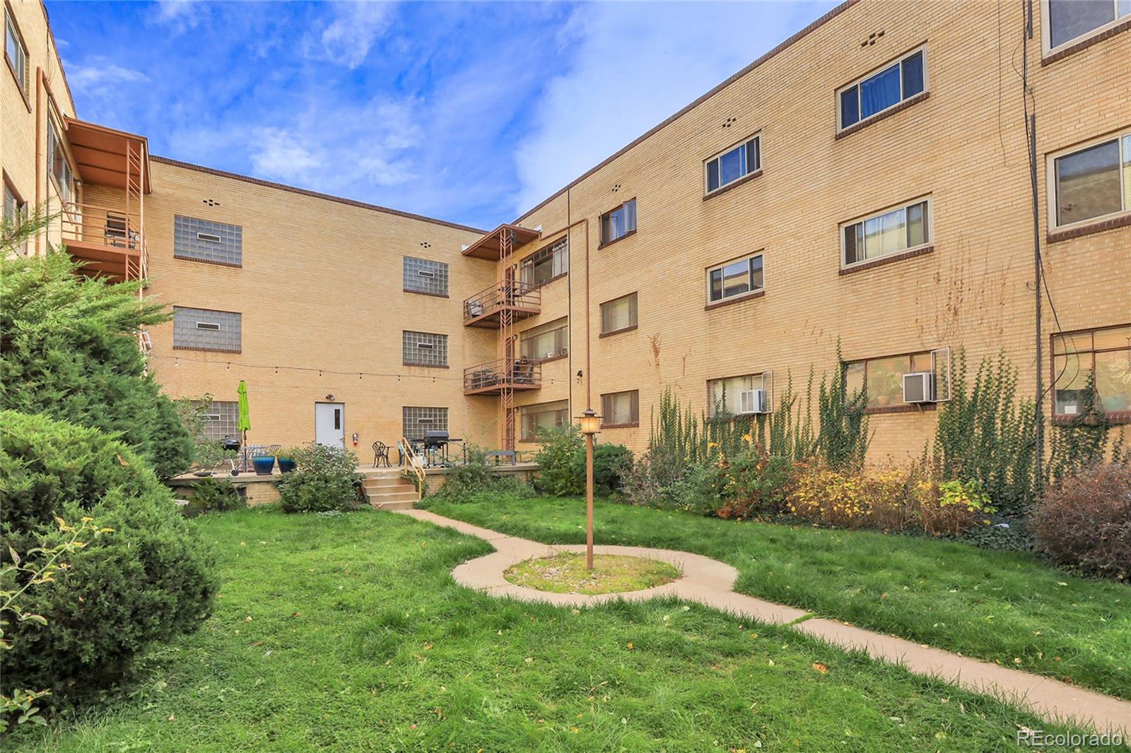1175 Emerson Street, Unit 202 Denver, CO 80218 - Photo 29 of 31 a view of a big building with a yard