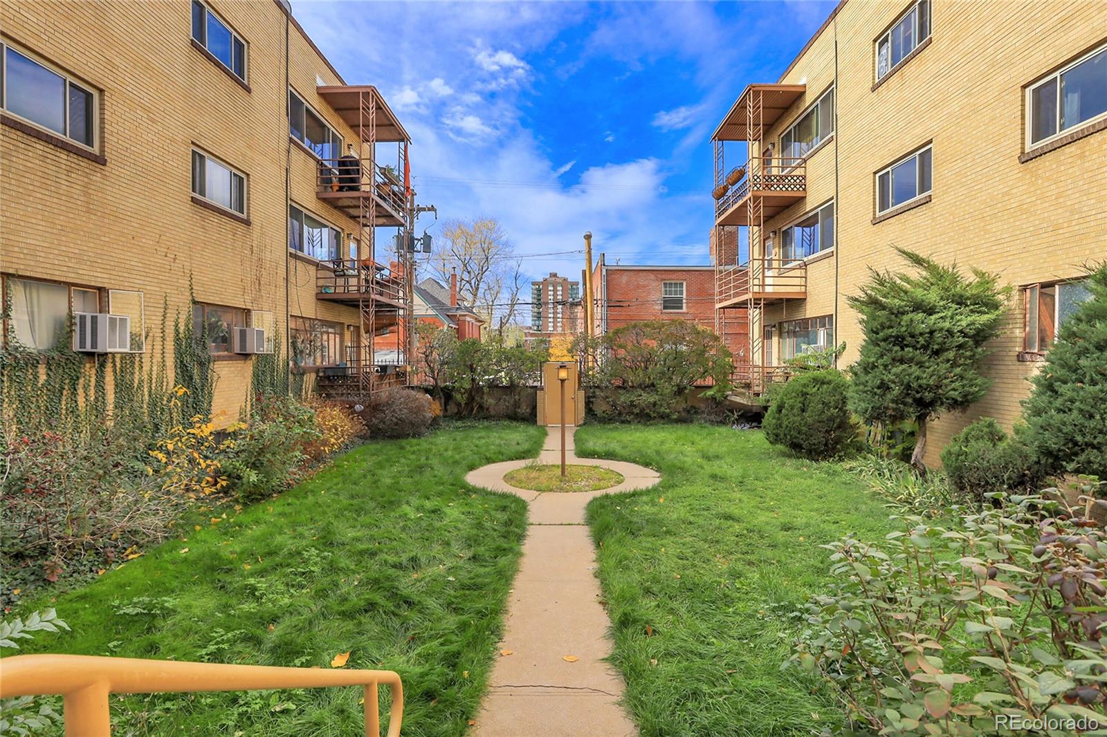 1175 Emerson Street, Unit 202 Denver, CO 80218 - Photo 30 of 31 a front view of a building with a garden