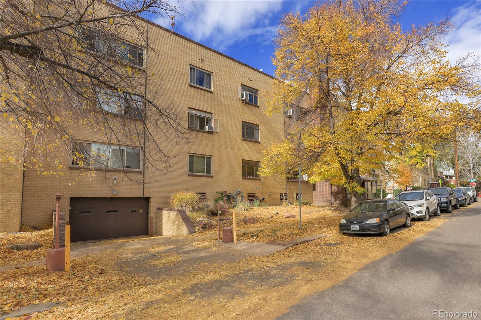 1175 Emerson Street, Unit 202 Denver, CO 80218 - Photo 5 of 31 a view of a building with cars