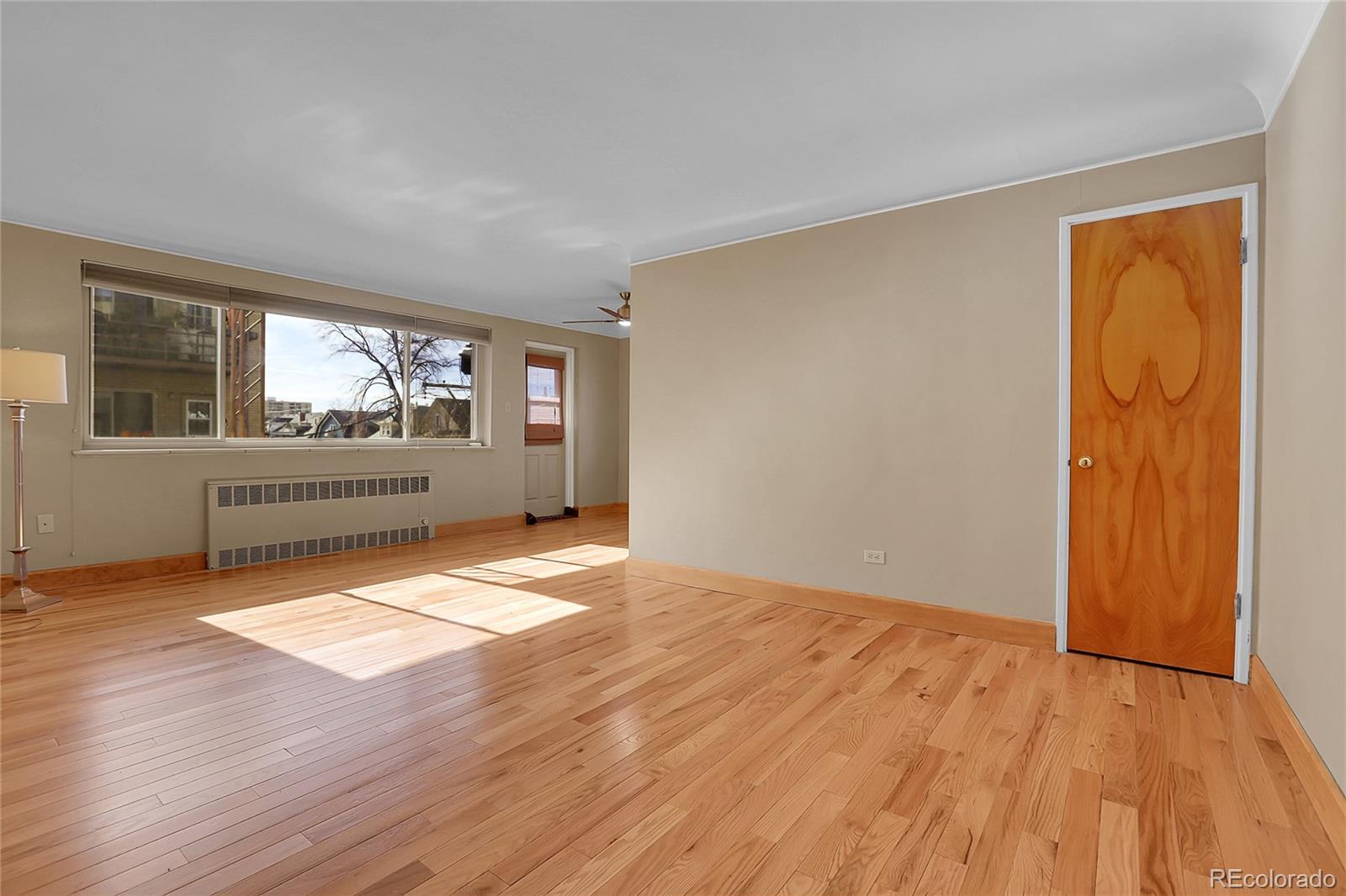 1175 Emerson Street, Unit 202 Denver, CO 80218 - Photo 6 of 31 a view of empty room with wooden floor and fan