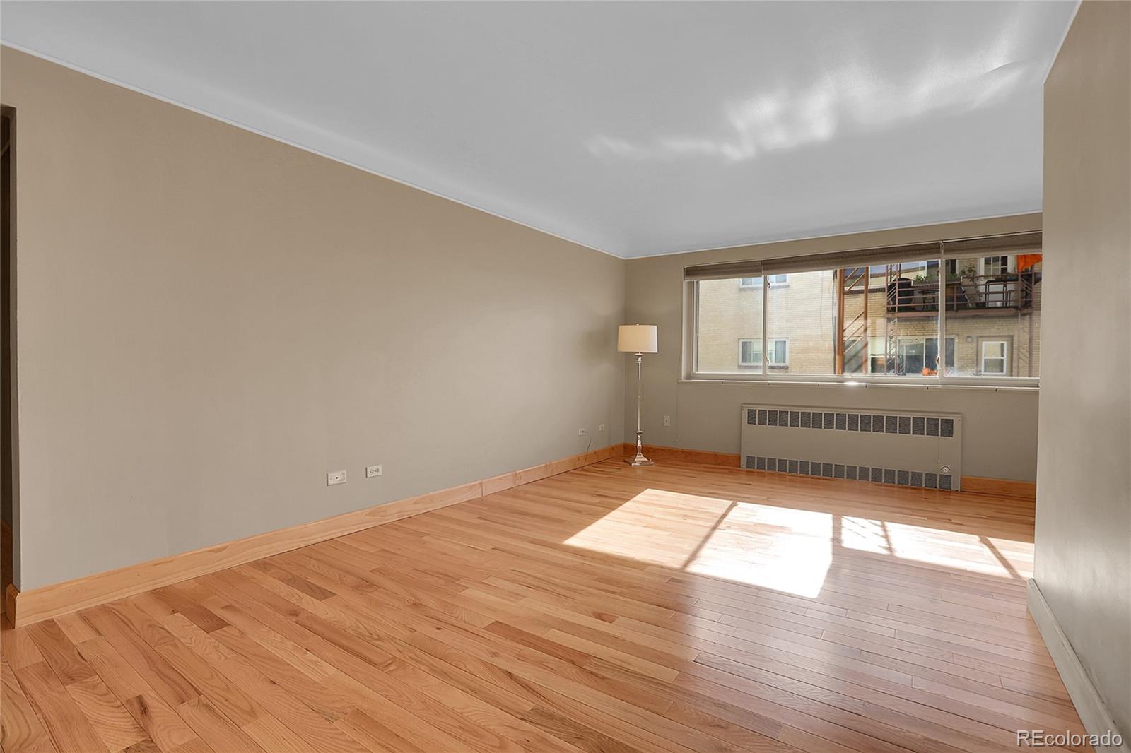 1175 Emerson Street, Unit 202 Denver, CO 80218 - Photo 8 of 31 wooden floor in an empty room with a window