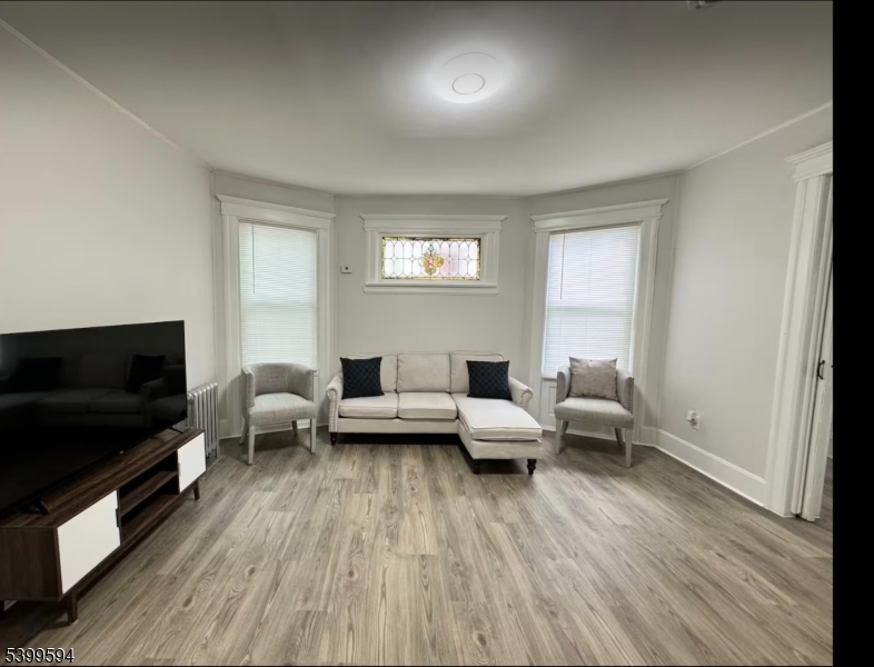 854 South 15th Street, Unit 2 Newark, NJ 07108 - Photo 2 of 9 a living room with furniture and a flat screen tv