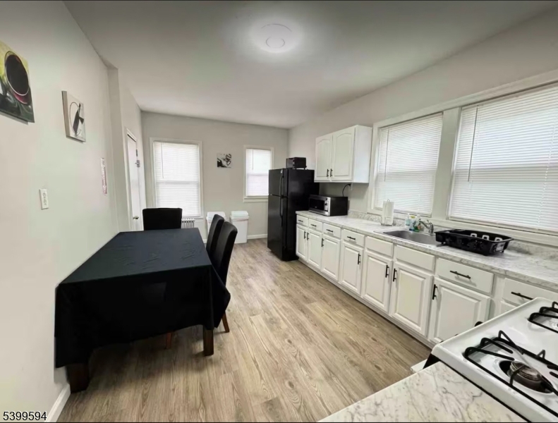 854 South 15th Street, Unit 2 Newark, NJ 07108 - Photo 3 of 9 a kitchen with a sink appliances and cabinets