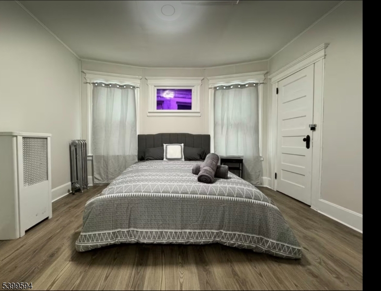 854 South 15th Street, Unit 2 Newark, NJ 07108 - Photo 5 of 9 a bedroom with a bed and wooden floor