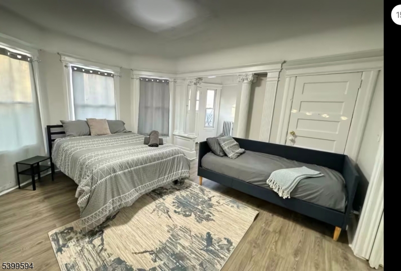 854 South 15th Street, Unit 2 Newark, NJ 07108 - Photo 6 of 9 a bedroom with a bed couch and a window