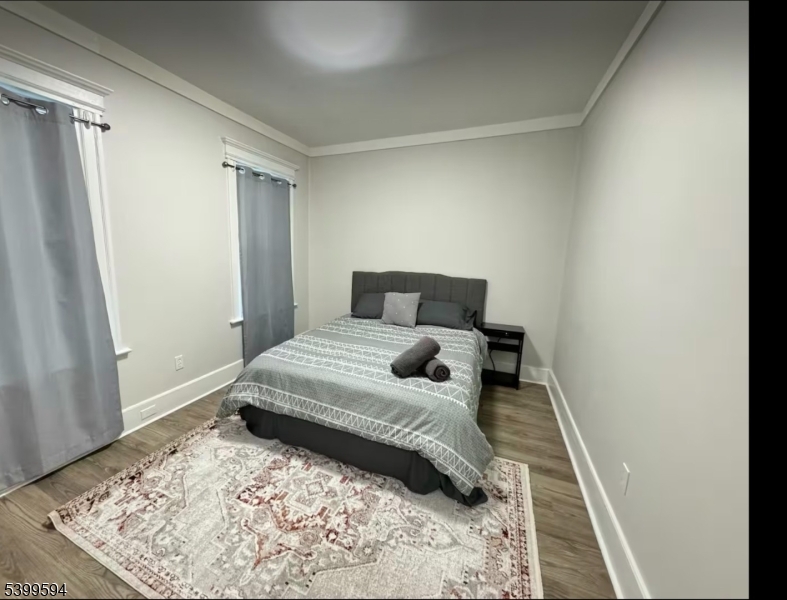 854 South 15th Street, Unit 2 Newark, NJ 07108 - Photo 7 of 9 a bedroom with a bed and wooden floor