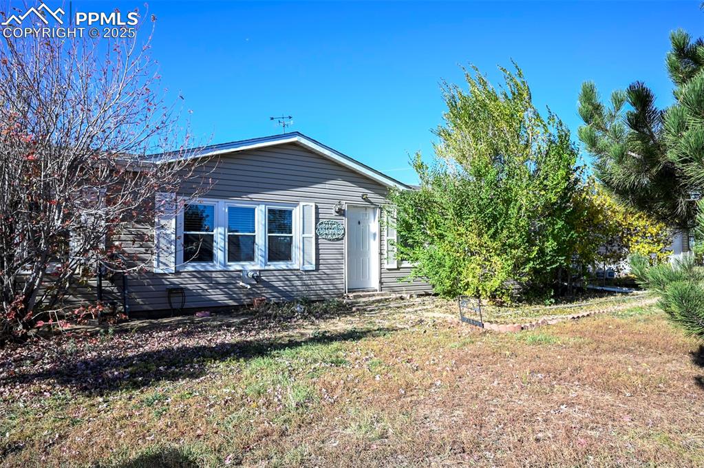 35355 Funk Road Calhan, CO 80808 - Photo 3 of 31 a front view of a house with a garden