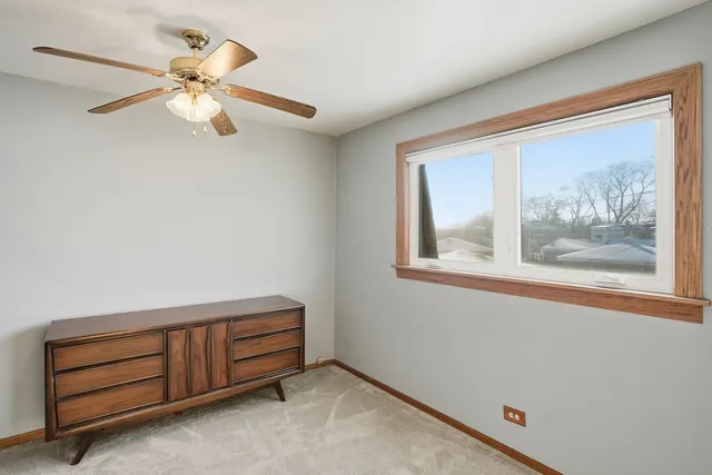 a room with a fan and a window