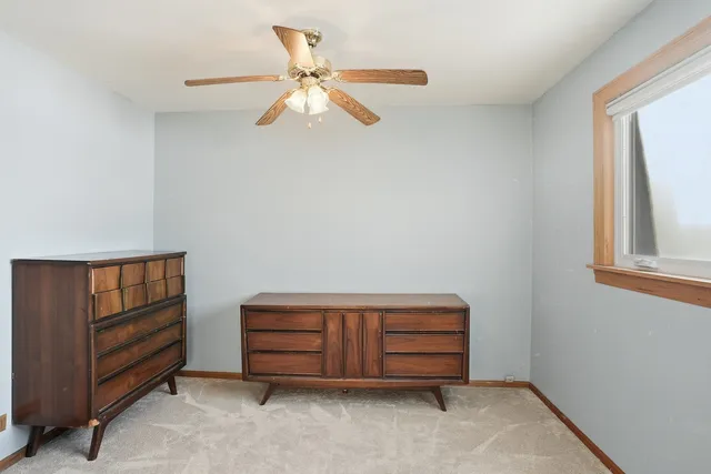 a room with a dresser and a window