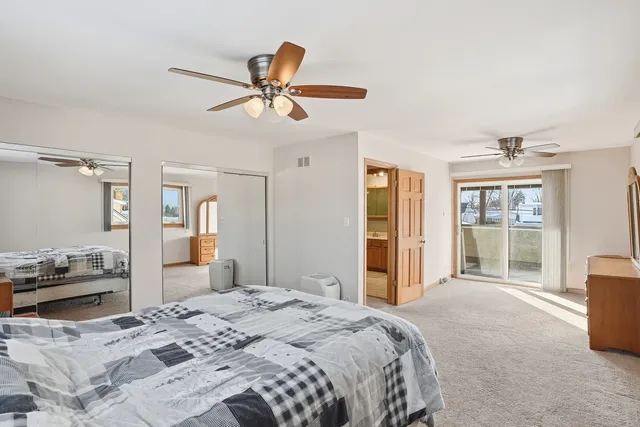 a bedroom with a large bed and a window