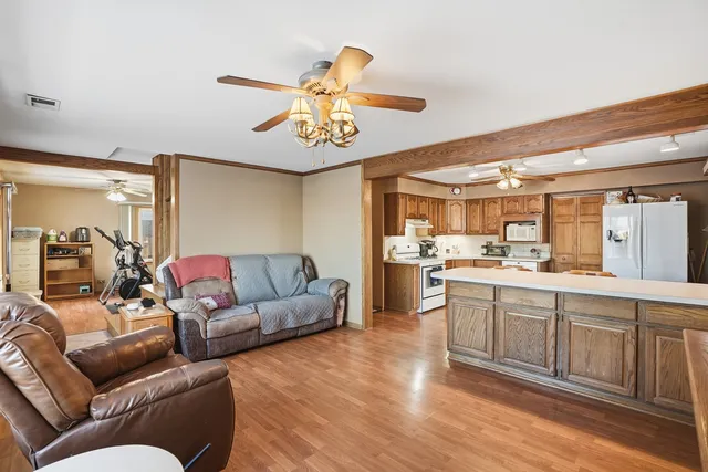 a living room with furniture and kitchen view