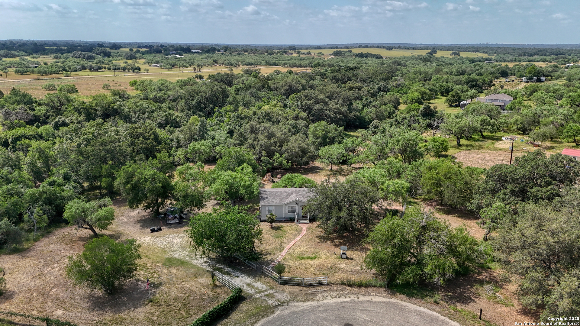 a view of a field of grass and trees