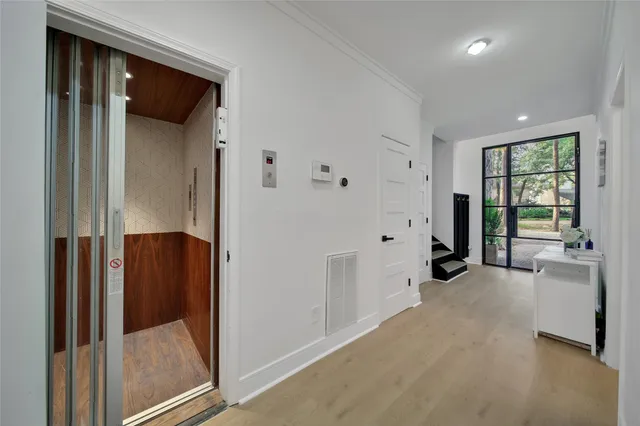 a room with chandelier pool table and flat screen tv