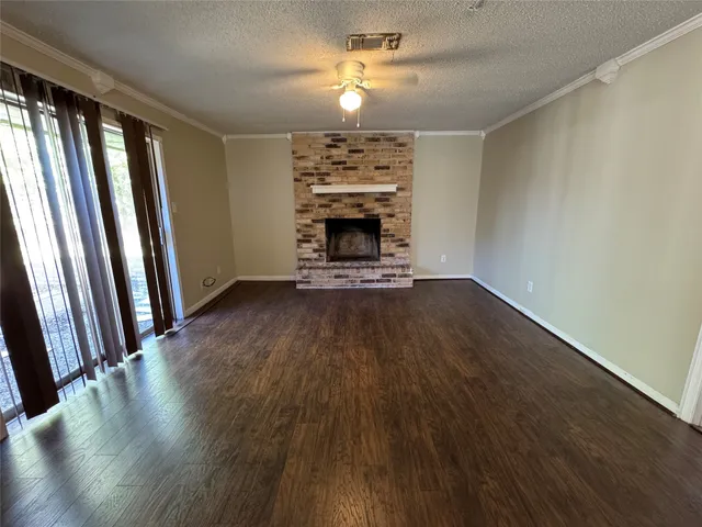 wooden floor in an empty room with a fireplace
