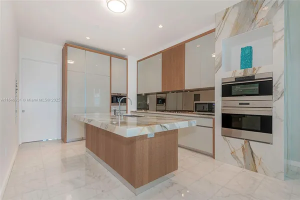 a kitchen with stainless steel appliances sink a microwave and cabinets