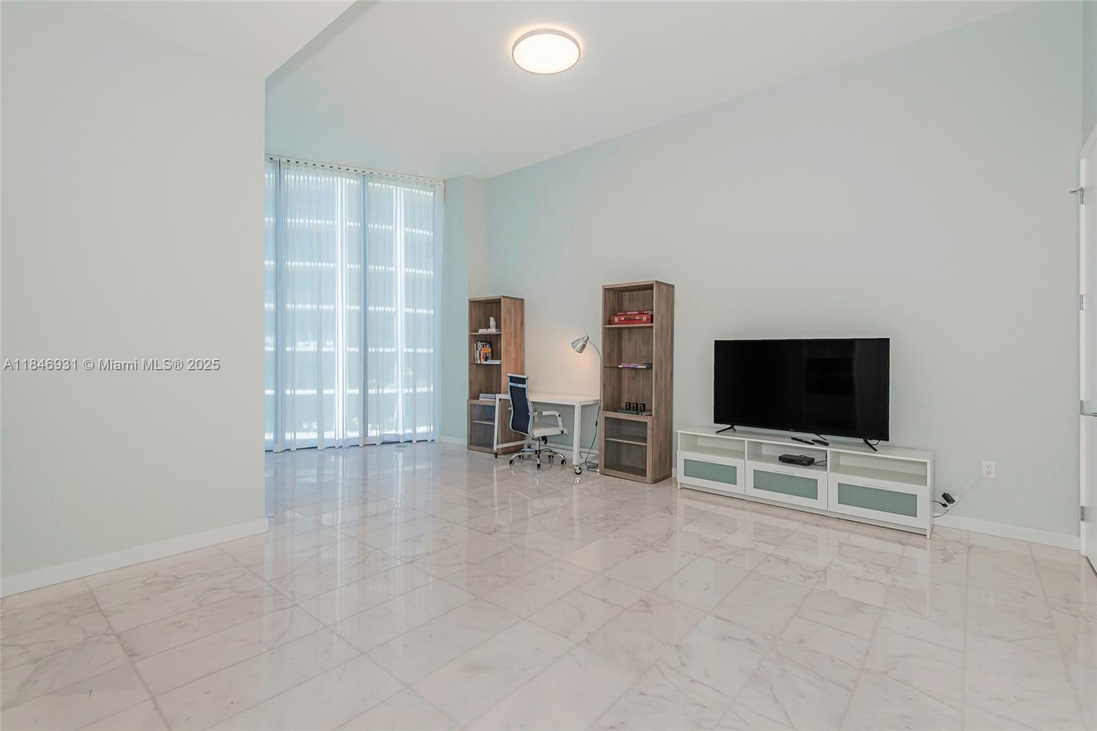 2821 South Bayshore Drive, Unit 7B Coconut Grove, FL 33133 - Photo 15 of 35 a view of a livingroom with furniture and a flat screen tv