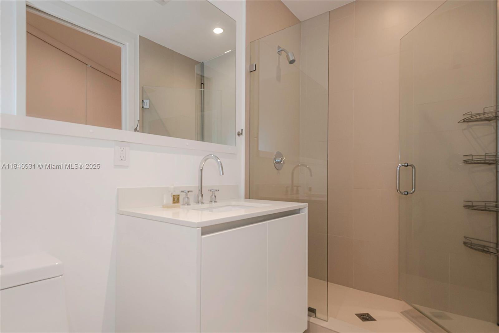 2821 South Bayshore Drive, Unit 7B Coconut Grove, FL 33133 - Photo 20 of 35 a bathroom with a sink a toilet and shower
