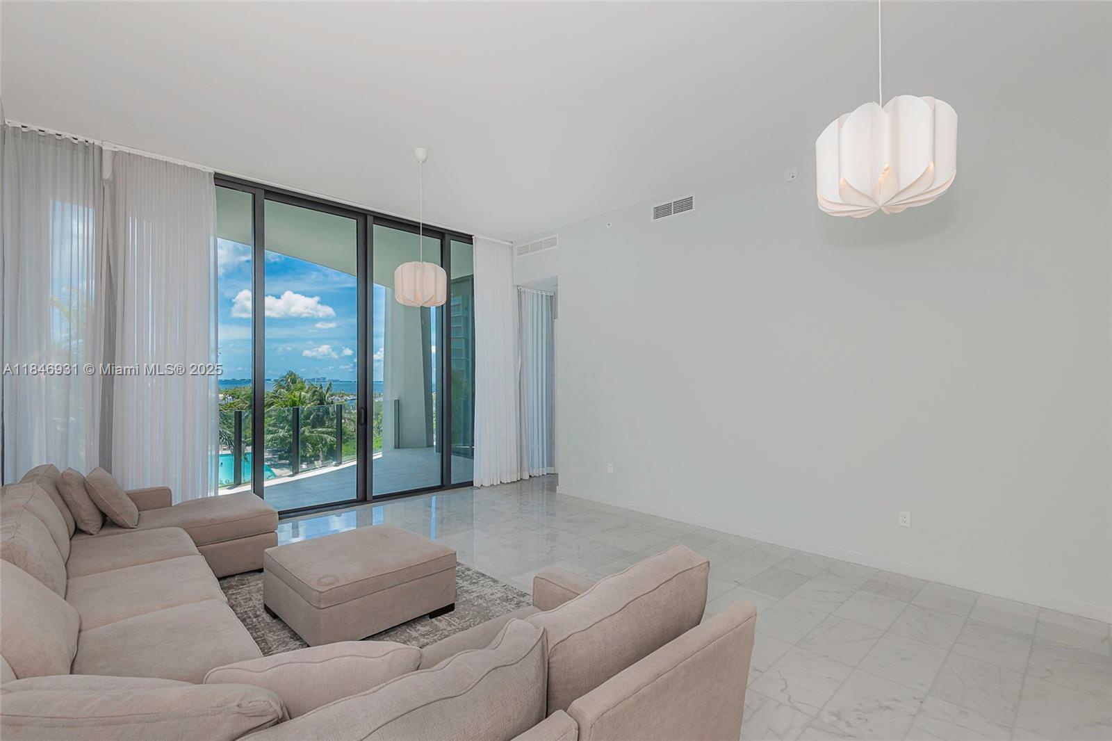 2821 South Bayshore Drive, Unit 7B Coconut Grove, FL 33133 - Photo 2 of 35 a living room with furniture and a large window
