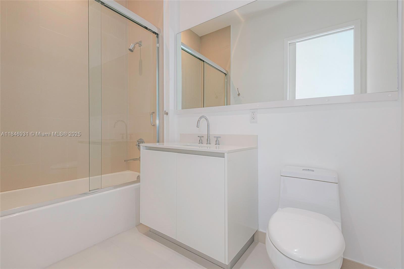 2821 South Bayshore Drive, Unit 7B Coconut Grove, FL 33133 - Photo 23 of 35 a bathroom with a toilet a sink and bathtub