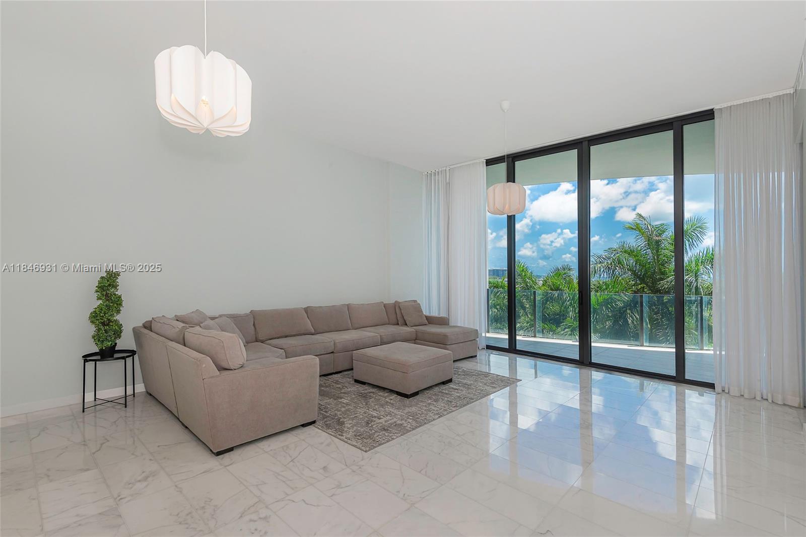 2821 South Bayshore Drive, Unit 7B Coconut Grove, FL 33133 - Photo 3 of 35 a living room with furniture and a large window