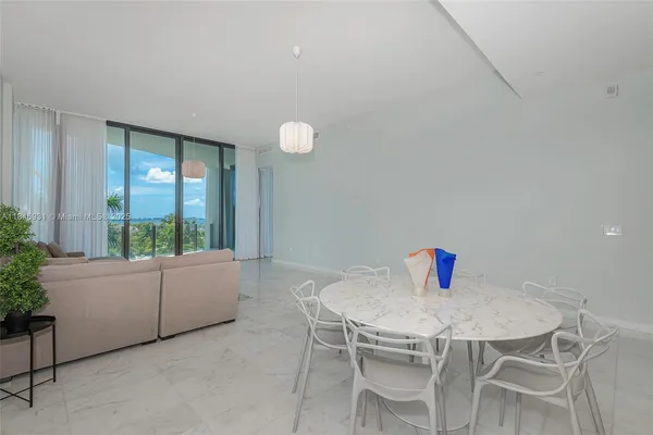 a dining room with furniture and window