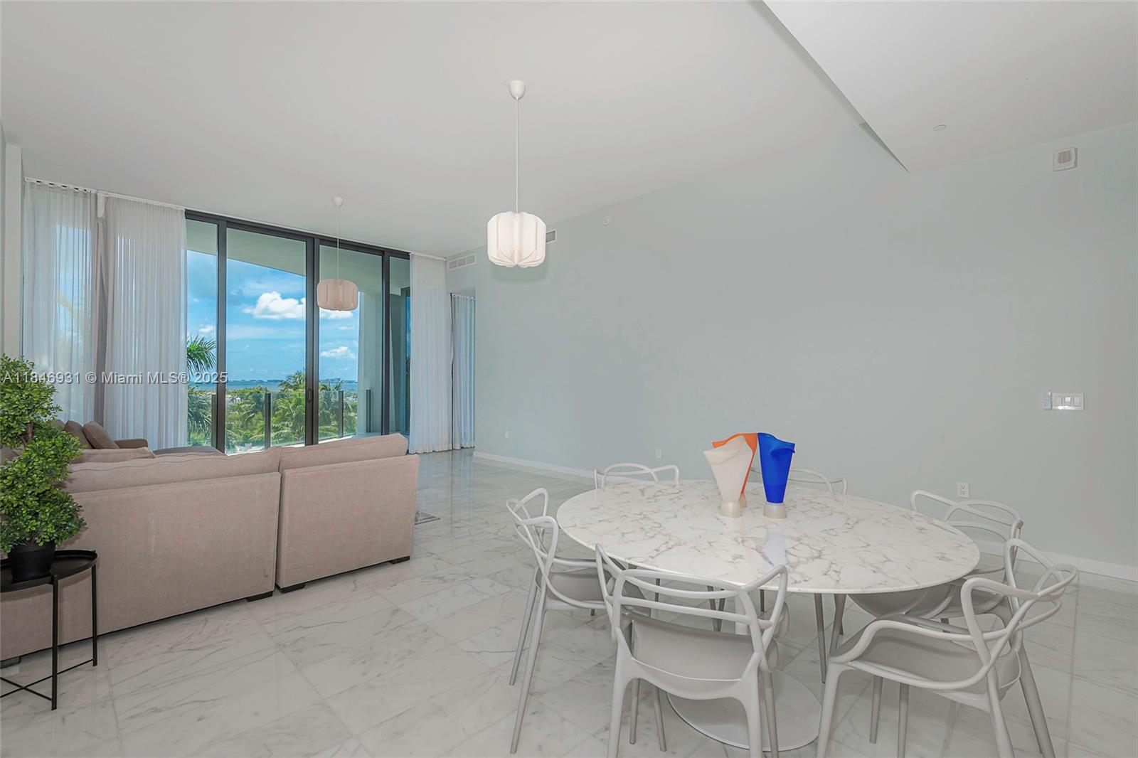2821 South Bayshore Drive, Unit 7B Coconut Grove, FL 33133 - Photo 6 of 35 a living room with furniture and a large window