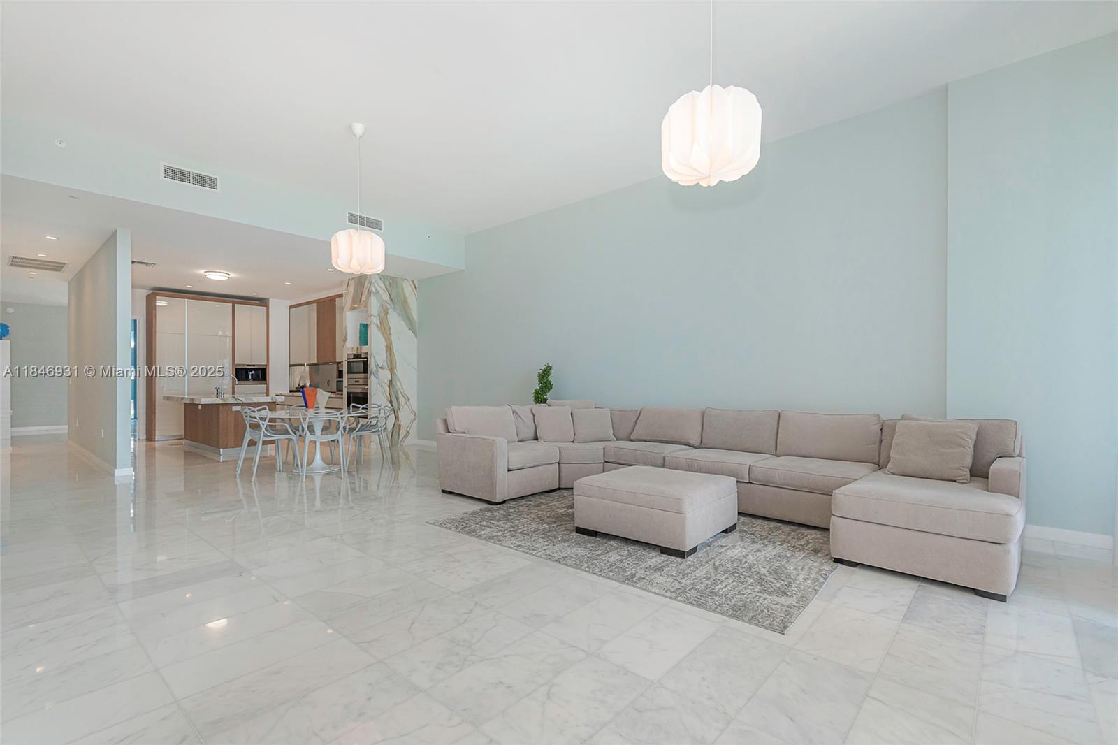 2821 South Bayshore Drive, Unit 7B Coconut Grove, FL 33133 - Photo 7 of 35 a living room with furniture and a large mirror