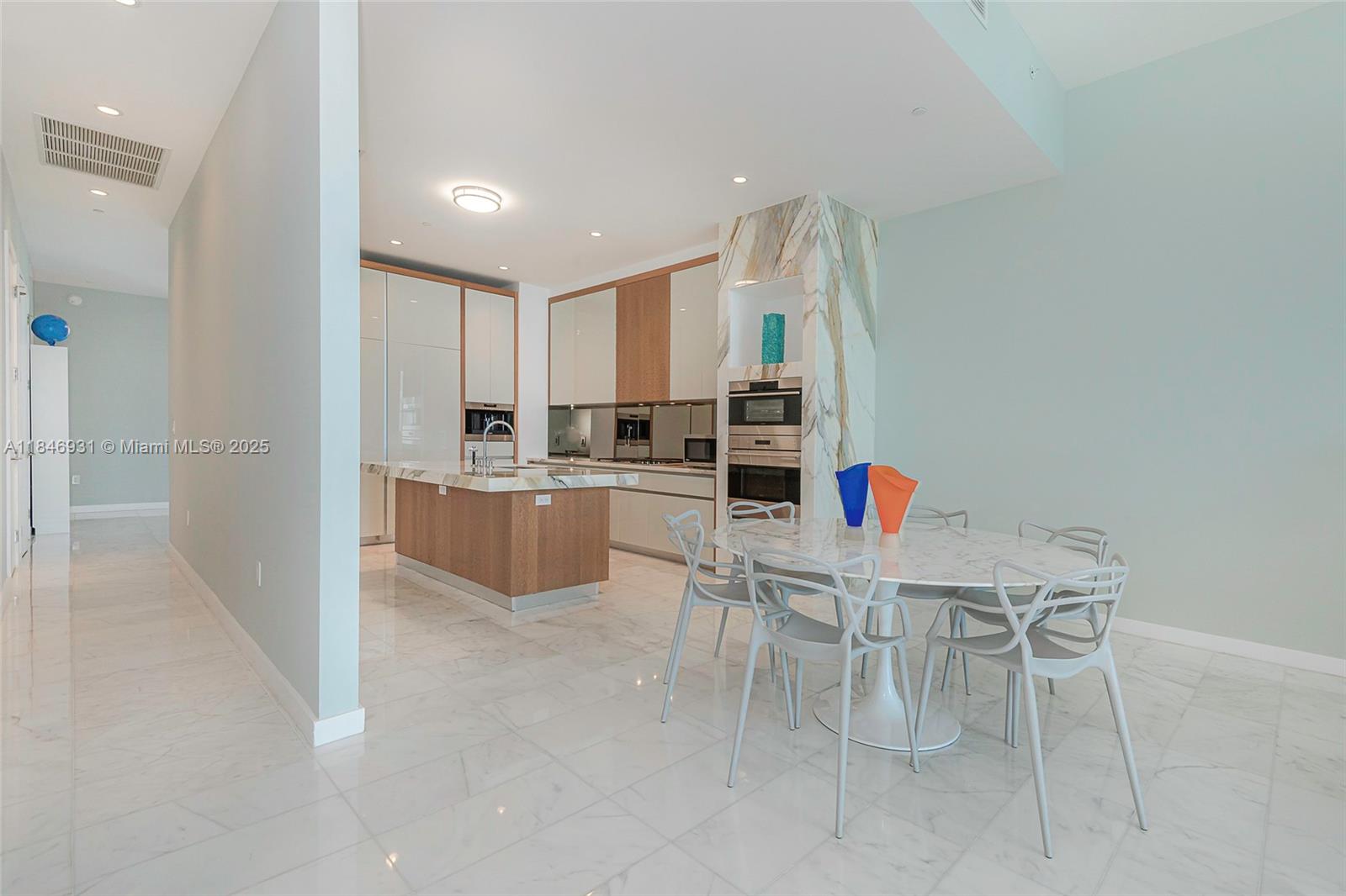 2821 South Bayshore Drive, Unit 7B Coconut Grove, FL 33133 - Photo 9 of 35 a kitchen with stainless steel appliances kitchen island granite countertop a sink and cabinets