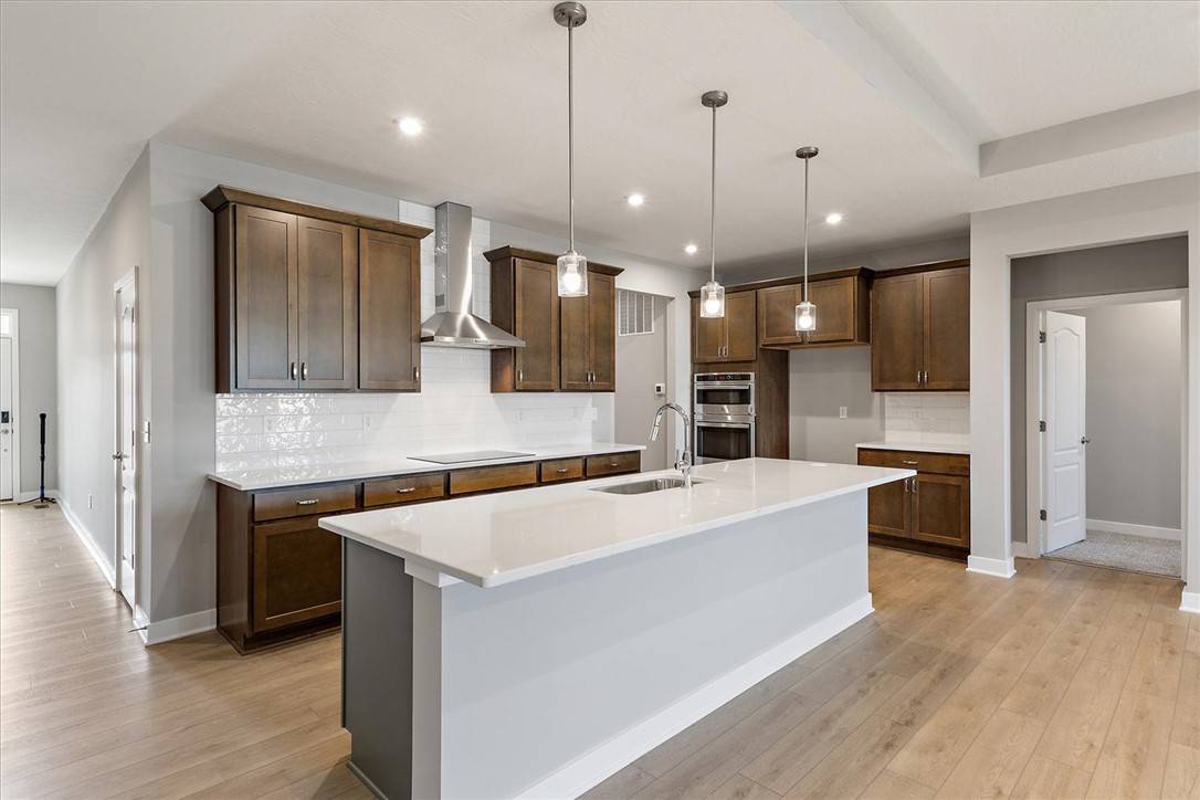 407 South Landon Lane Springfield, OH 45502 - Photo 2 of 30 This kitchen showcases a central island, rich cabinetry, and sleek appliances.