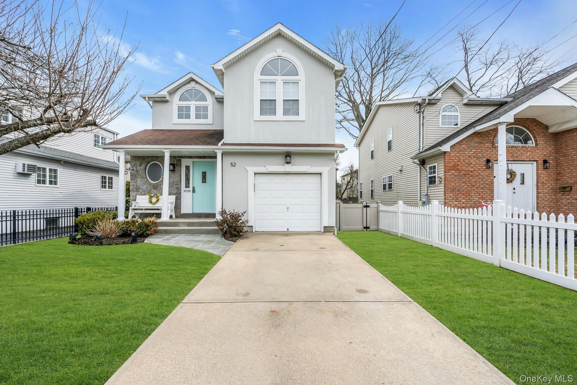 52 Edgewood Road Port Washington, NY 11050 - Photo 1 of 29 a front view of a house with a yard and trees