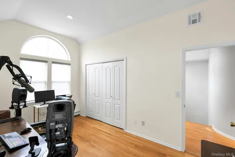 a view of workspace with wooden floor windows