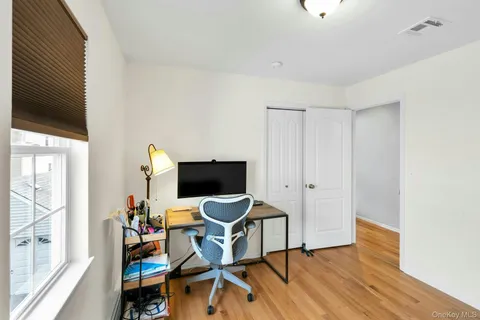 a view of a workspace with furniture and wooden floor