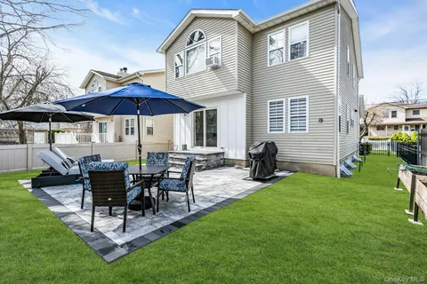 a view of a house with backyard and sitting area