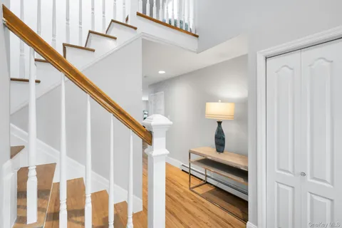 a view of entryway and hall with wooden floor
