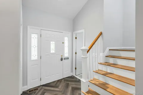 a view of entryway with wooden floor and staircase
