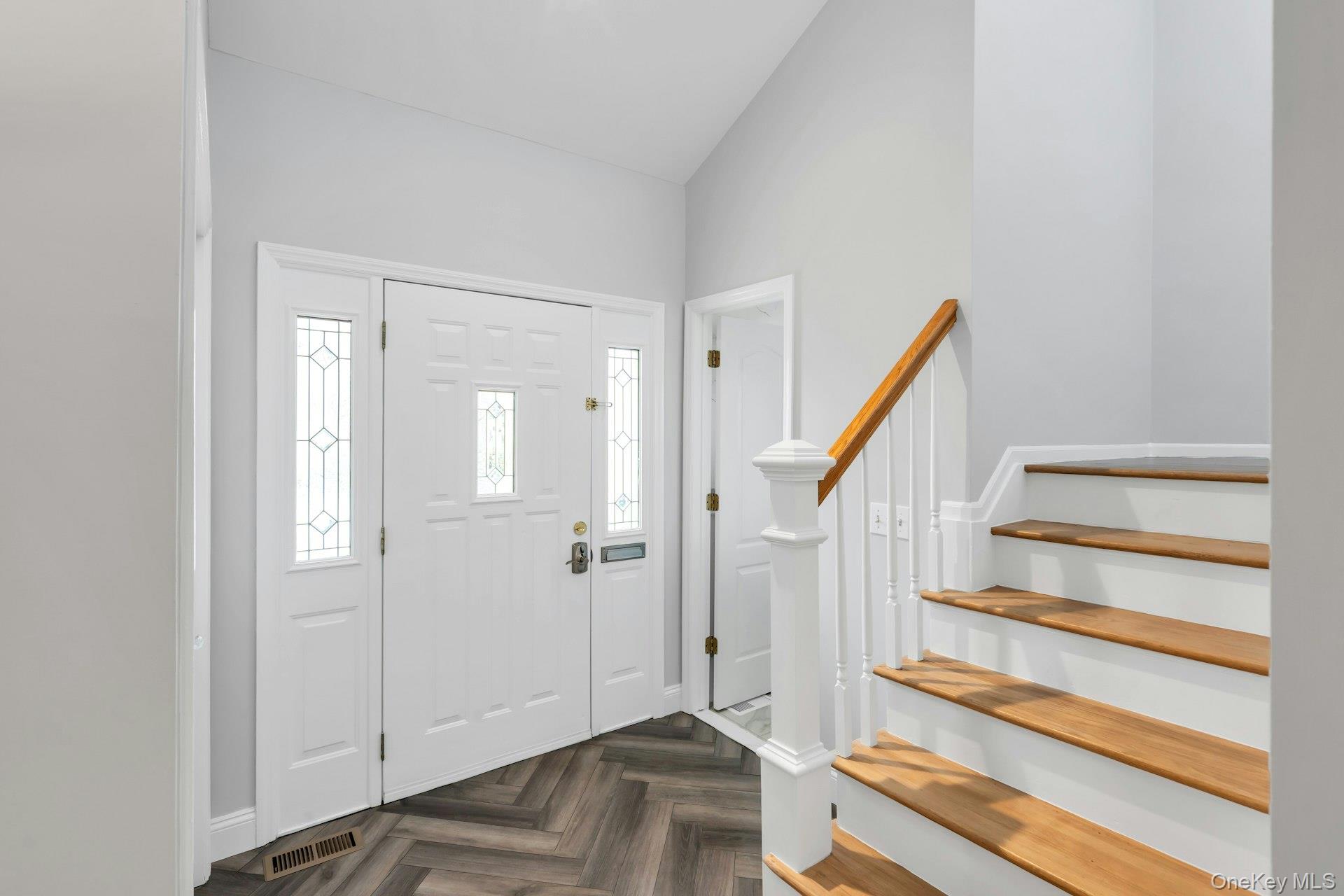 52 Edgewood Road Port Washington, NY 11050 - Photo 4 of 29 a view of entryway with wooden floor and staircase
