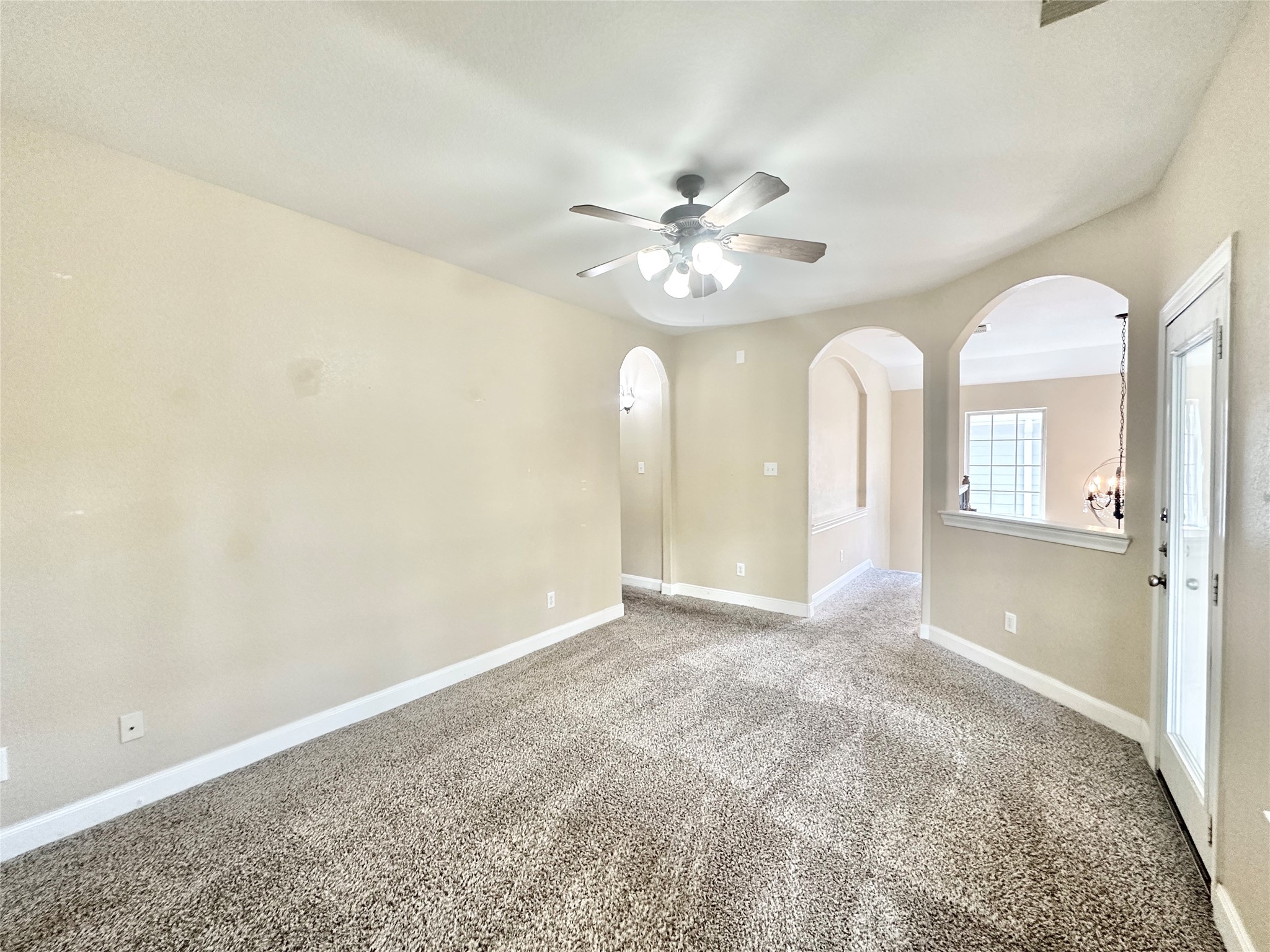 43 Panterra Way Spring, TX 77382 - Photo 11 of 17 an empty room with chandelier fan and windows