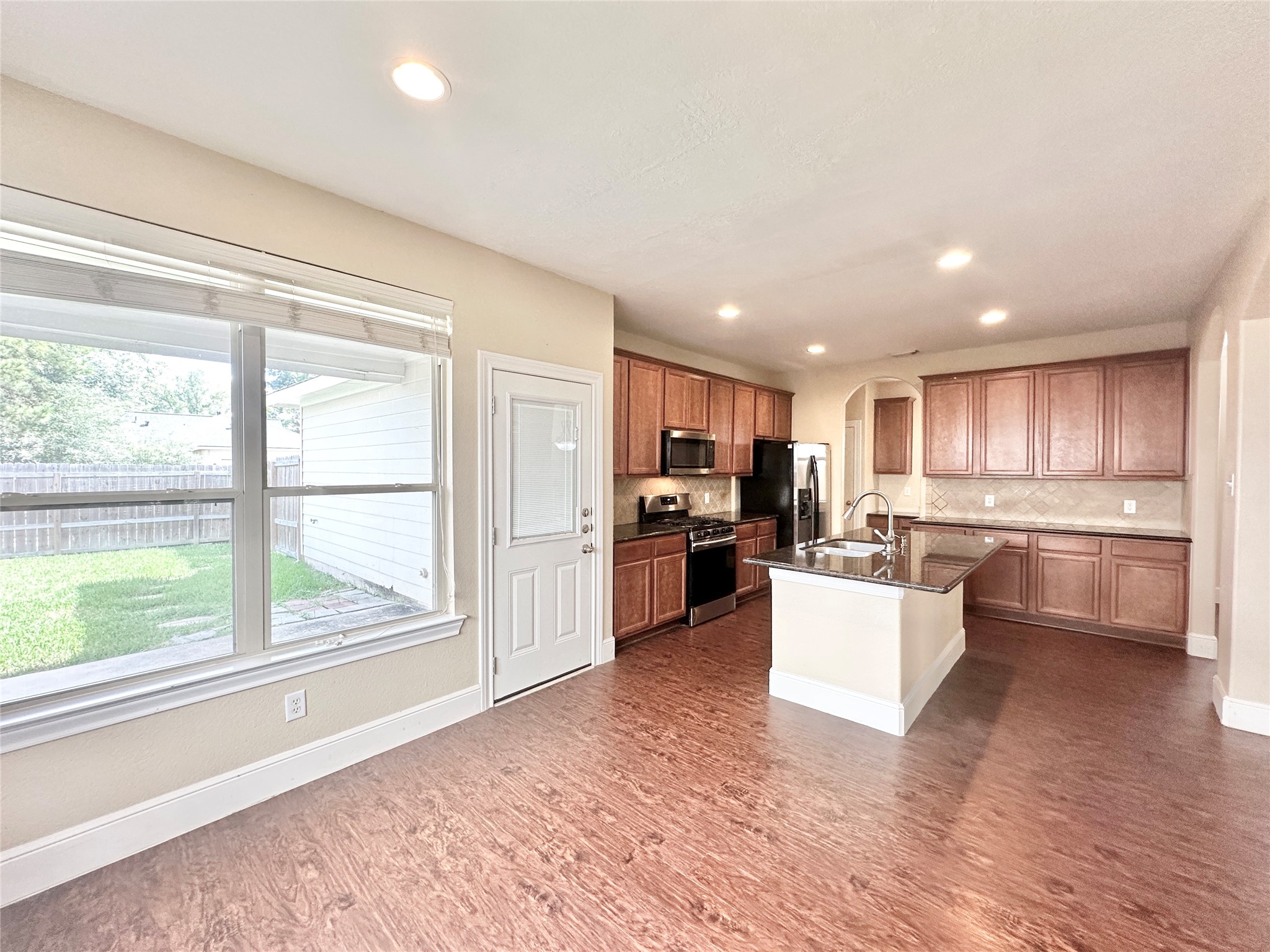43 Panterra Way Spring, TX 77382 - Photo 7 of 17 a kitchen with kitchen island wooden floors and stainless steel appliances