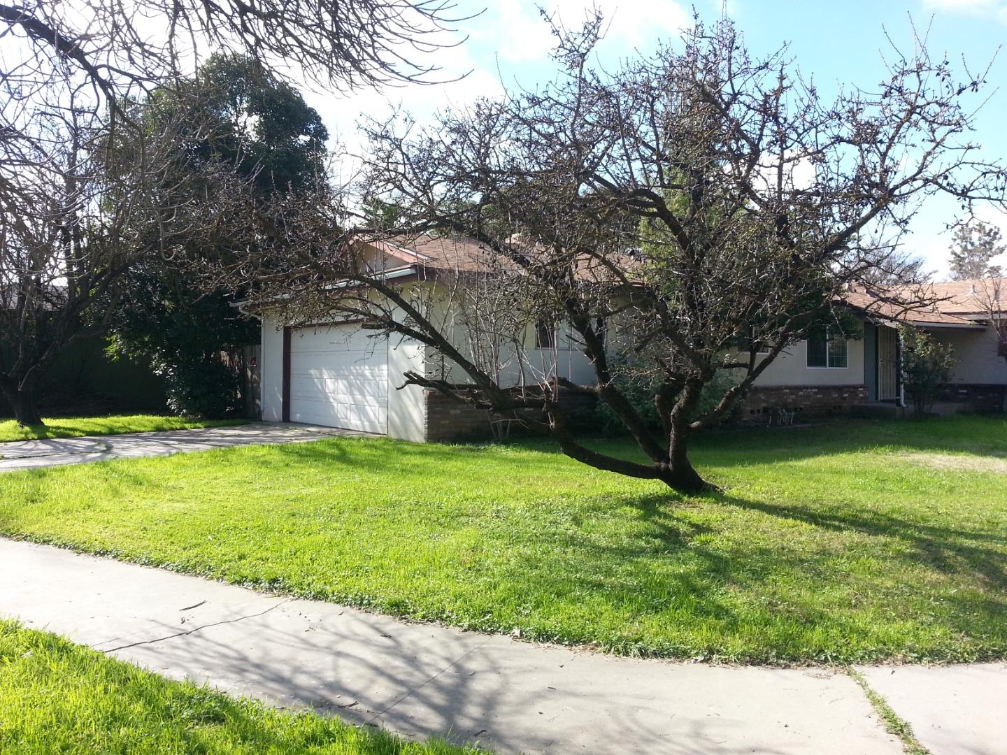 856 Modoc Street Merced, CA 95340 - Photo 4 of 16 a house with a tree in front of it